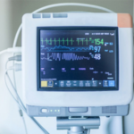 A medical monitor displaying vital signs in a hospital setting.